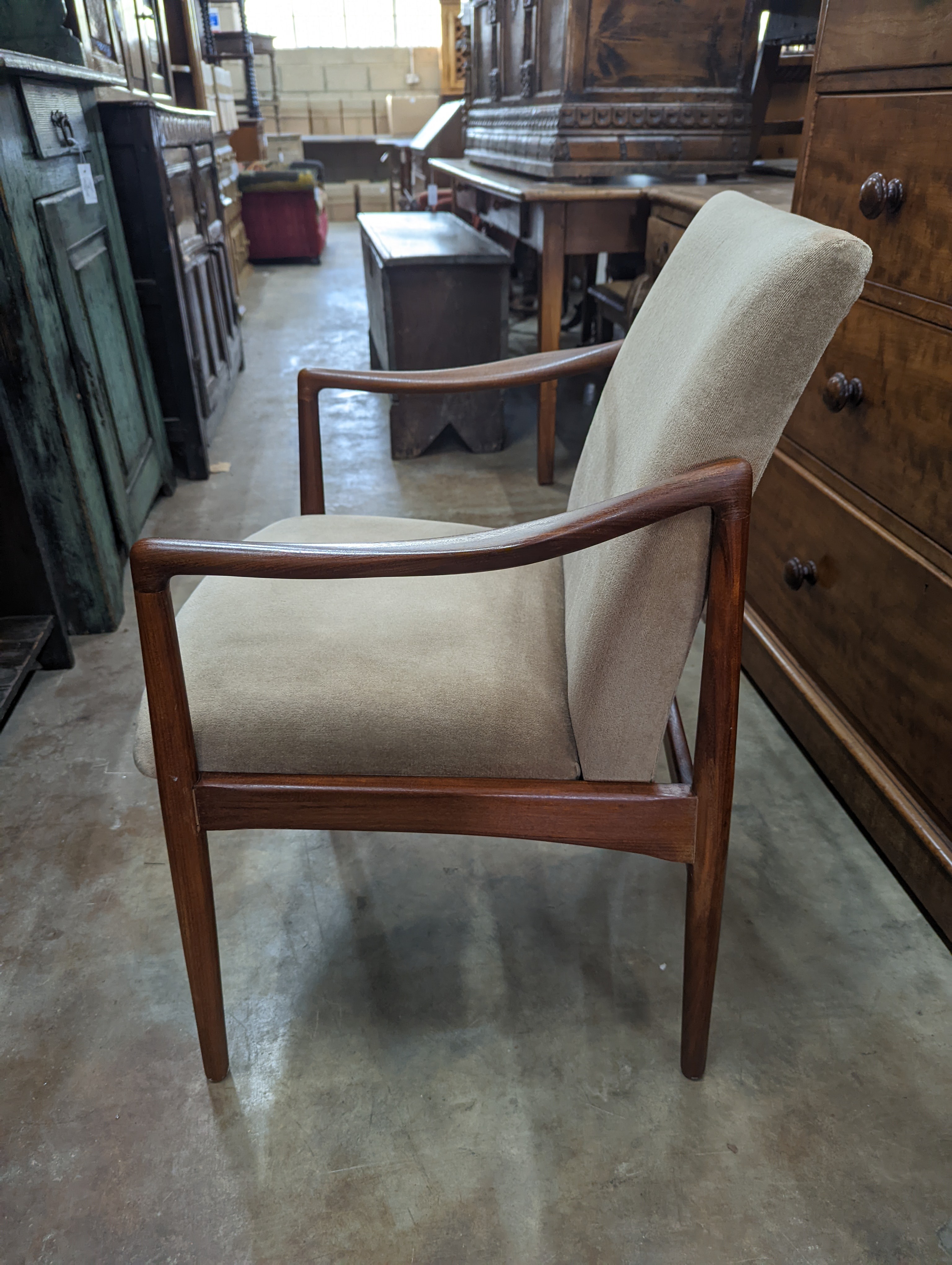 A pair of mid century teak upholstered elbow chairs, width 54cm, depth 63cm, height 84cm